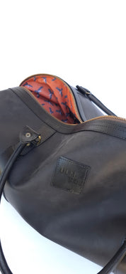 Bolso ULMMO Cuero Negro con forro cóndor naranjo