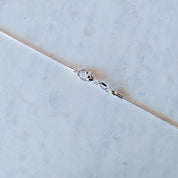 Collar Padre Nuestro bañado en oro blanco